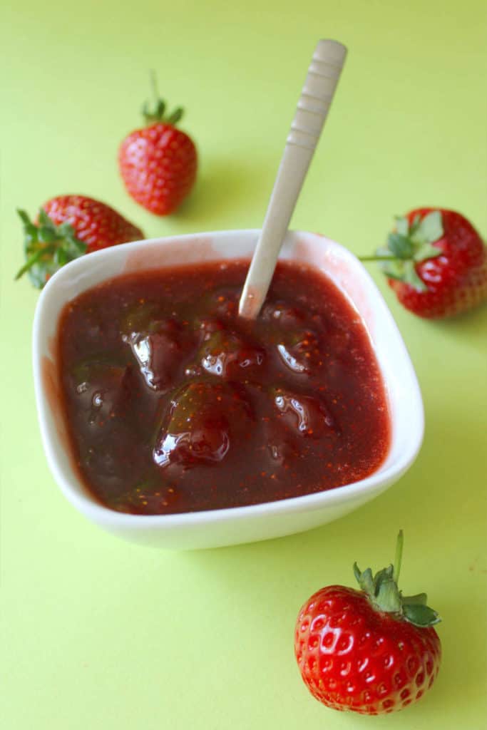 strawberry jam in a bowl with spoon